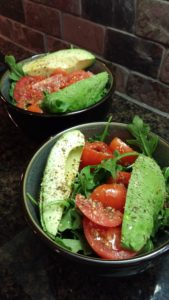 Green salad with avocado tomatoes