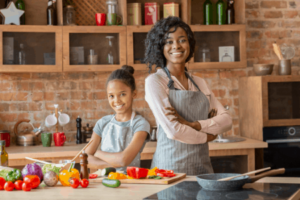 Mom and daughter in kitchen cooking together